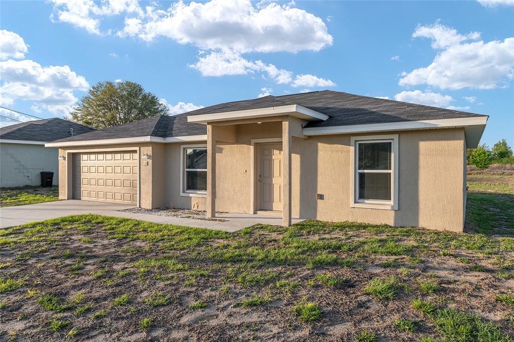 71 Juniper Trail Loop Ocala, FL 34480 - Photo 9 of 58 a front view of a house with a garden