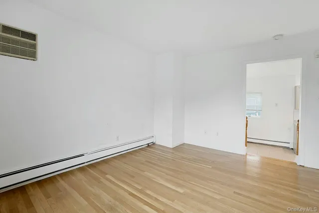 a view of a room with wooden floor