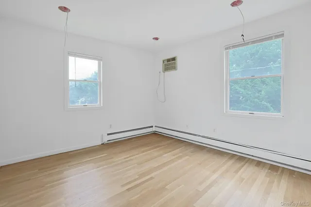a view of a room with wooden floor and windows
