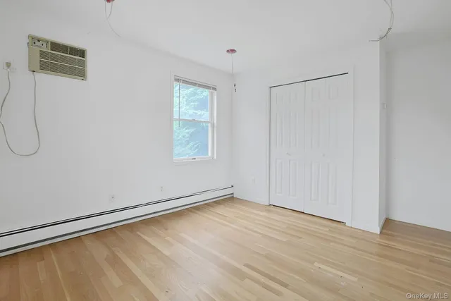 a view of a room with wooden floor and windows