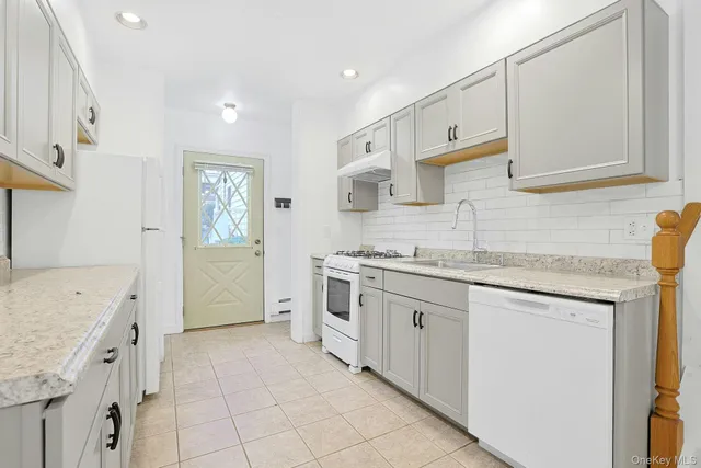 a kitchen with granite countertop a sink and cabinets