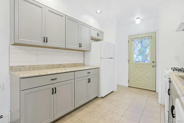 a kitchen with white cabinets and a sink