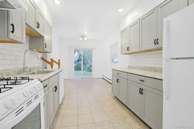 a kitchen with stainless steel appliances granite countertop a stove and a refrigerator