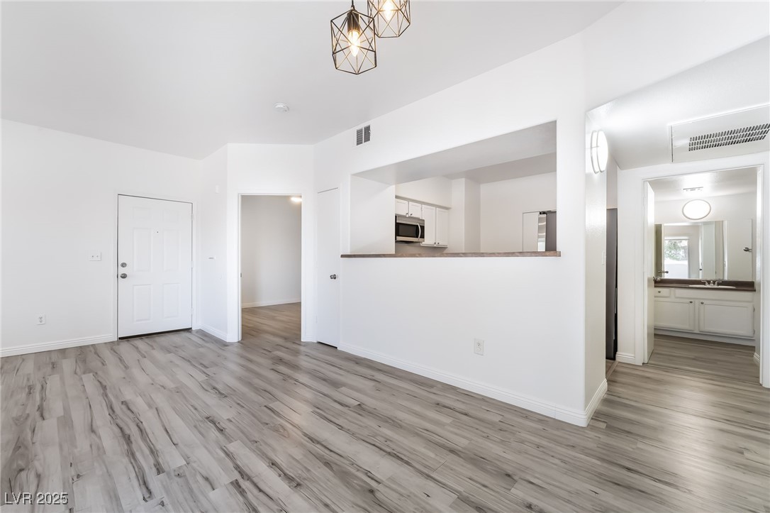 7255 West Sunset Road, Unit 1148 Las Vegas, NV 89113 - Photo 13 of 62 Unfurnished living room with light wood-type flooring