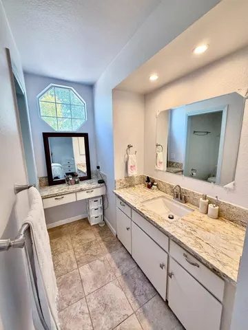 a large bathroom with a large tub and sink