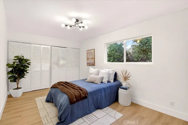 a bedroom with a bed and a potted plant
