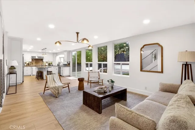 a living room with furniture and view of kitchen