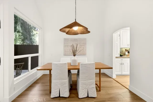 a dining room with furniture and wooden floor