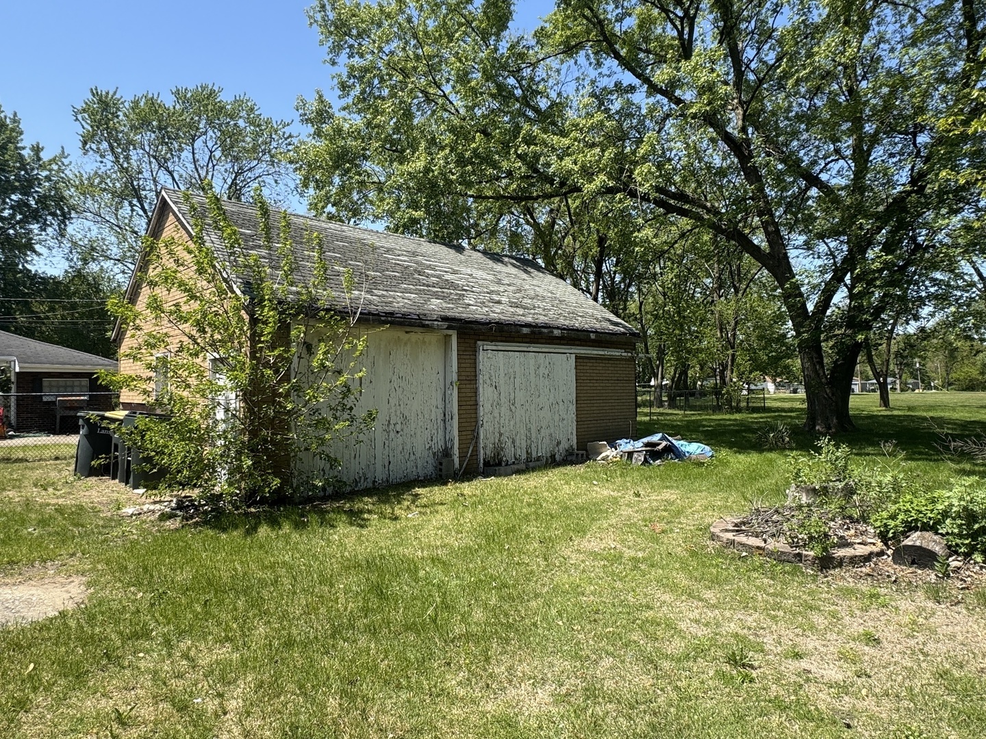 3226 181st Street Lansing, IL 60438 - Photo 20 of 38 a view of a backyard with plants and large trees