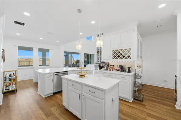 a kitchen with a sink a stove and chairs