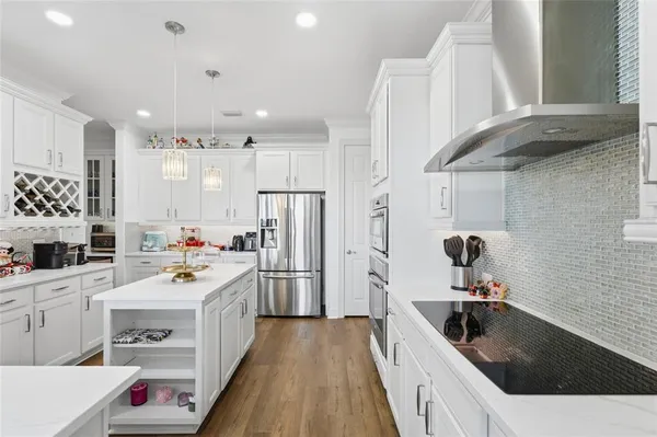 a kitchen with a sink stove and refrigerator