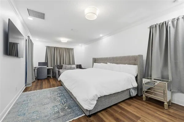 a bedroom with a bed and a large mirror