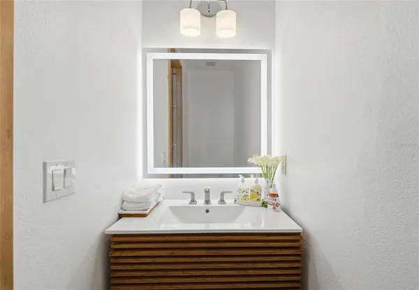 a bathroom with a sink and a mirror