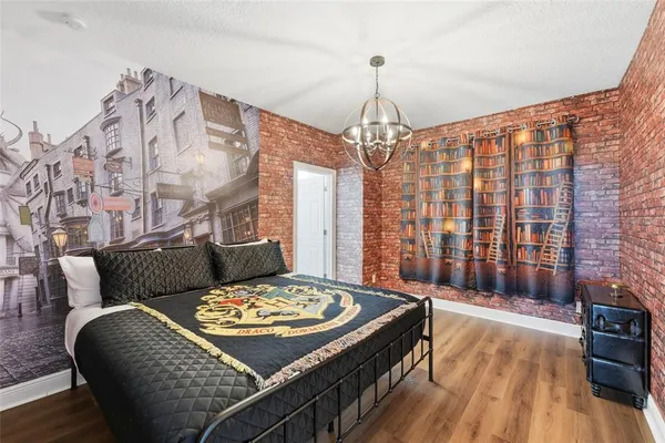 a living room with a bed and a chandelier