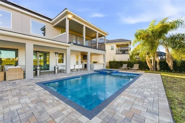 a view of a house with swimming pool and sitting area