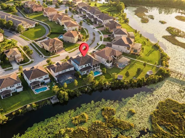 an aerial view of residential houses with outdoor space