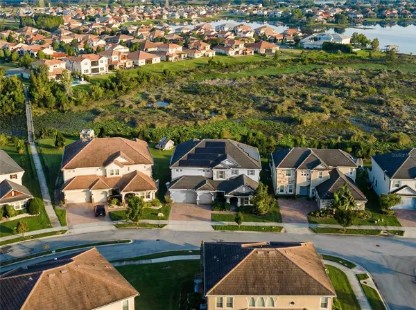 an aerial view of a house with a garden and trees