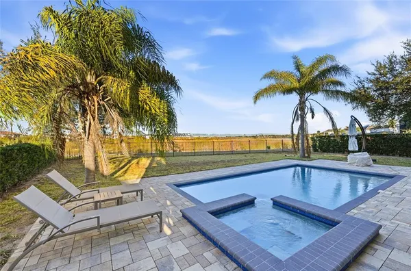 a view of swimming pool with chairs