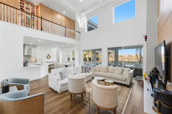 a living room with furniture a flat screen tv and large window