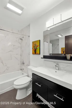 a bathroom with a sink a toilet and a bathtub