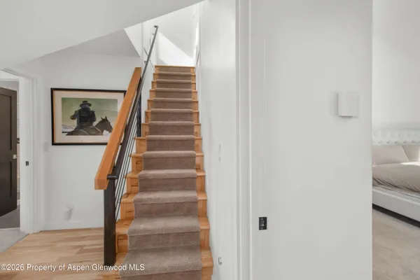 a view of staircase with wooden floor and windows