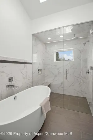 a bathroom with a bathtub and shower