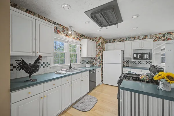 a kitchen with sink refrigerator and stove