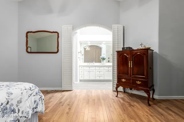 a bedroom with a bed and a mirror