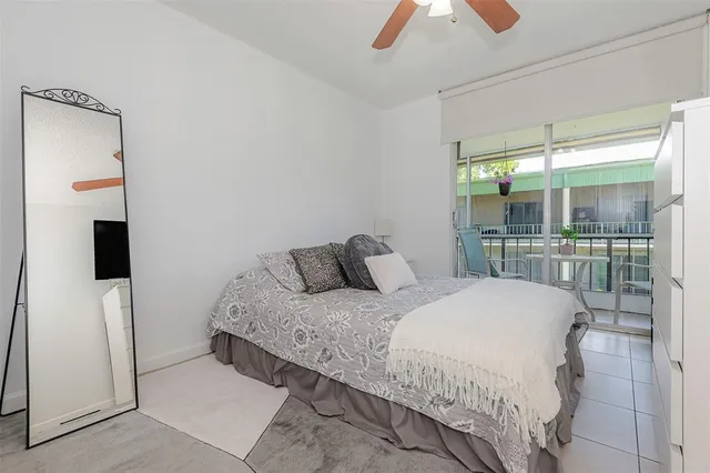 a bedroom with a balcony a bed and a chandelier