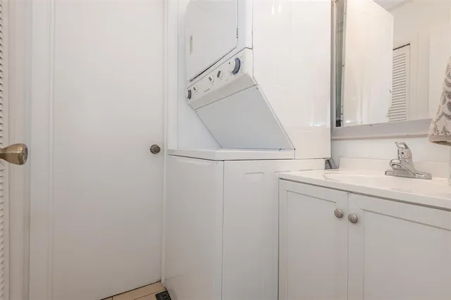 a bathroom with a sink and mirror with toilet