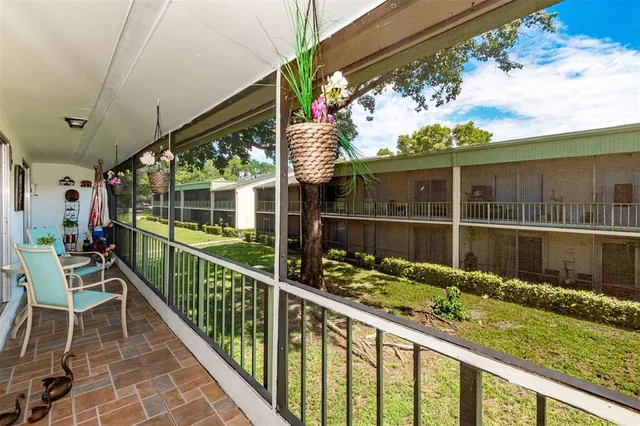 a view of a chairs and table in the balcony