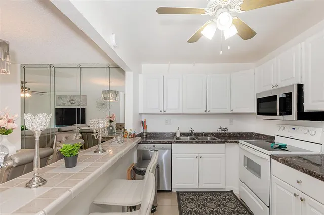 a kitchen with a sink stove and microwave