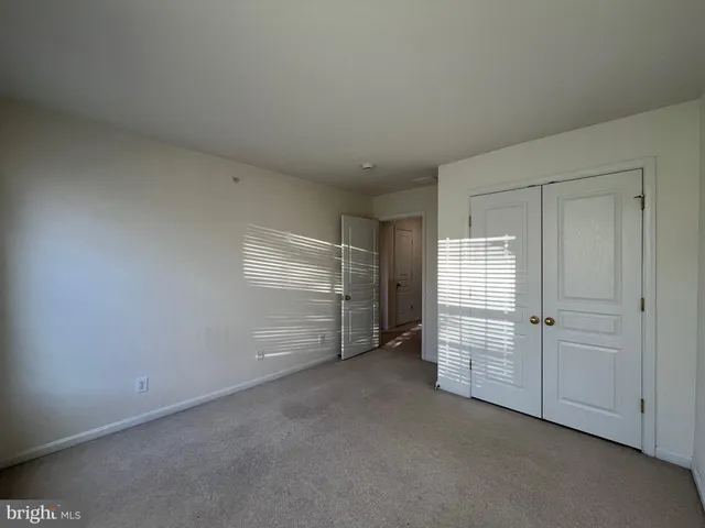 an empty room with wooden floor and a window