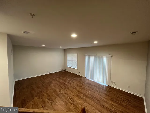 an empty room with wooden floor