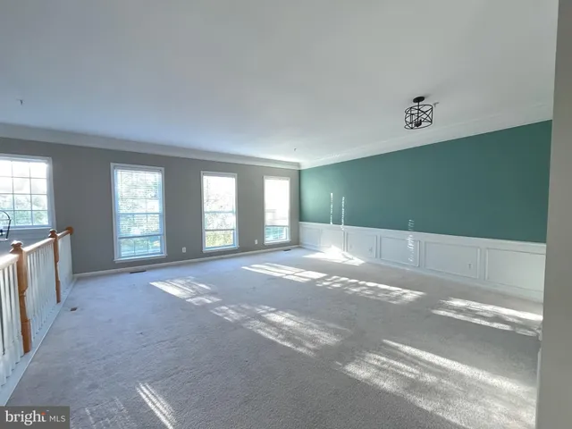 a view of kitchen with kitchen island wooden floor and living room