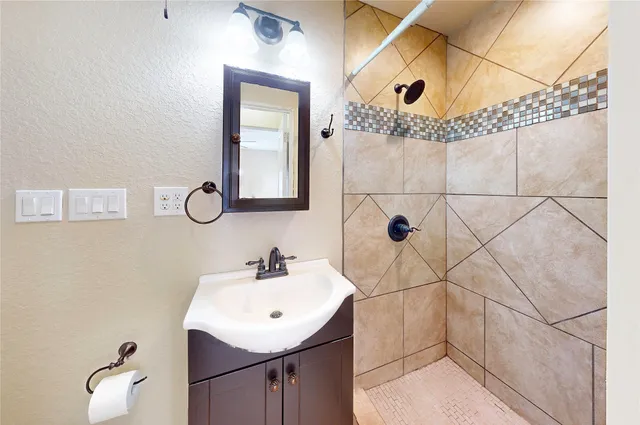 a view of an empty room and chandelier fan