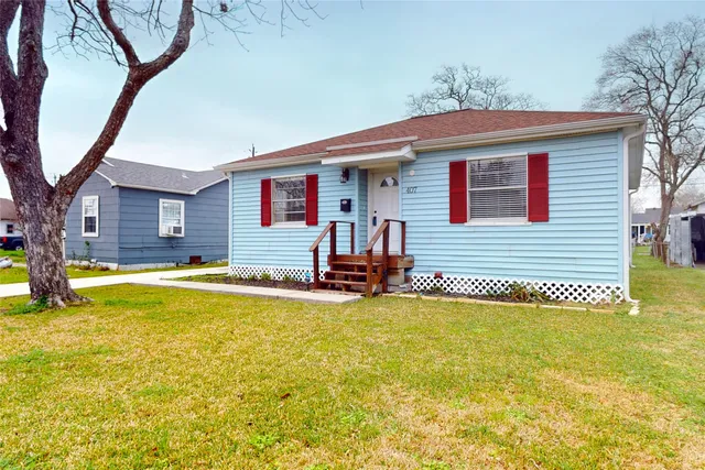 a view of a house with pool and a tree