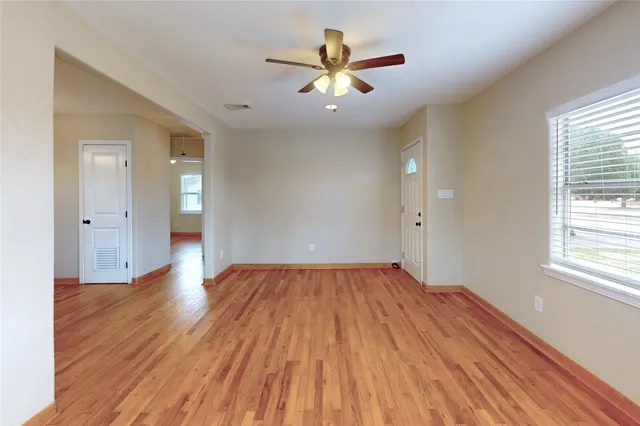 wooden floor in an empty room with a window
