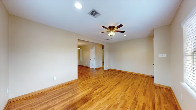 wooden floor in an empty room with a window