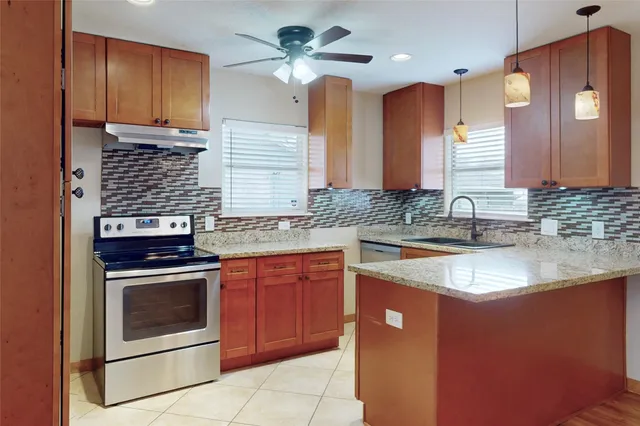 a spacious bathroom with a granite countertop sink a mirror and shower
