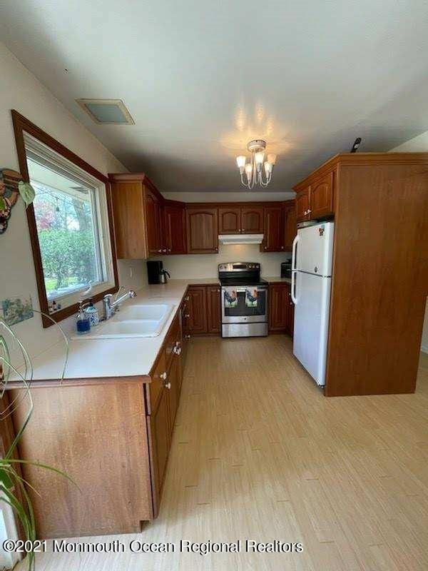 25 Half Mile Road Red Bank, NJ 07701 - Photo 3 of 5 a kitchen with stainless steel appliances kitchen island granite countertop a refrigerator stove and oven