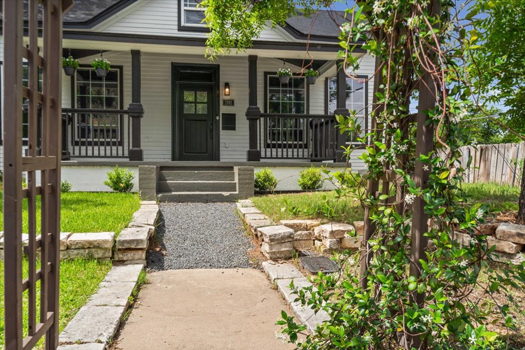 1201 Garden Street, Unit A Austin, TX 78702 - Photo 26 of 30 White siding exterior featuring a covered front porch with dark columns and railing