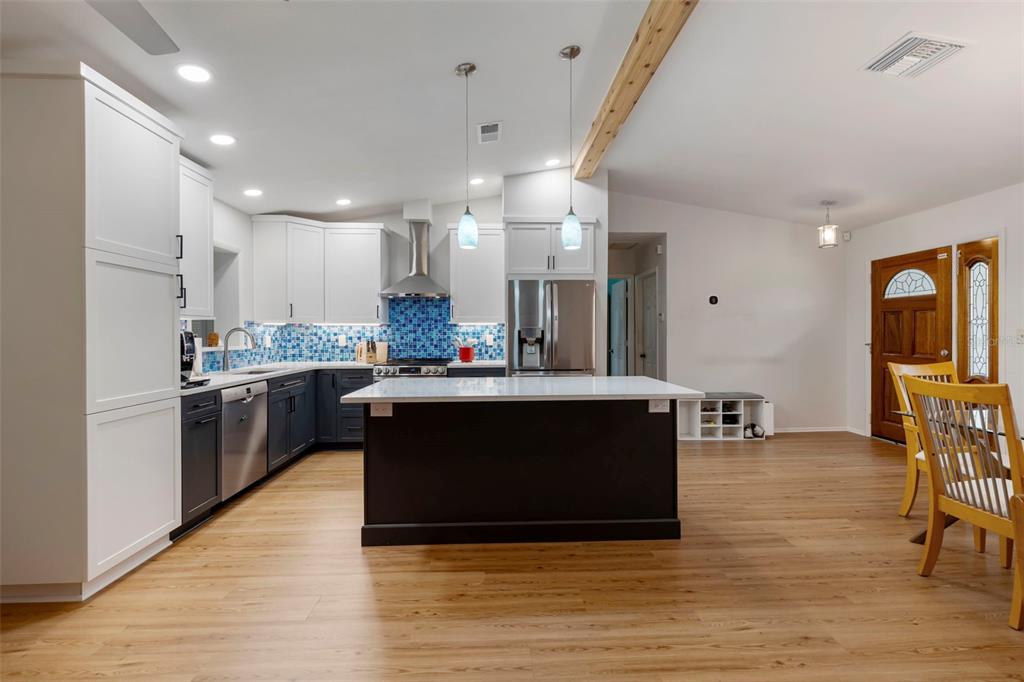 818 Eunice Drive Tarpon Springs, FL 34689 - Photo 11 of 59 a kitchen with stainless steel appliances granite countertop a stove a sink a refrigerator and a microwave