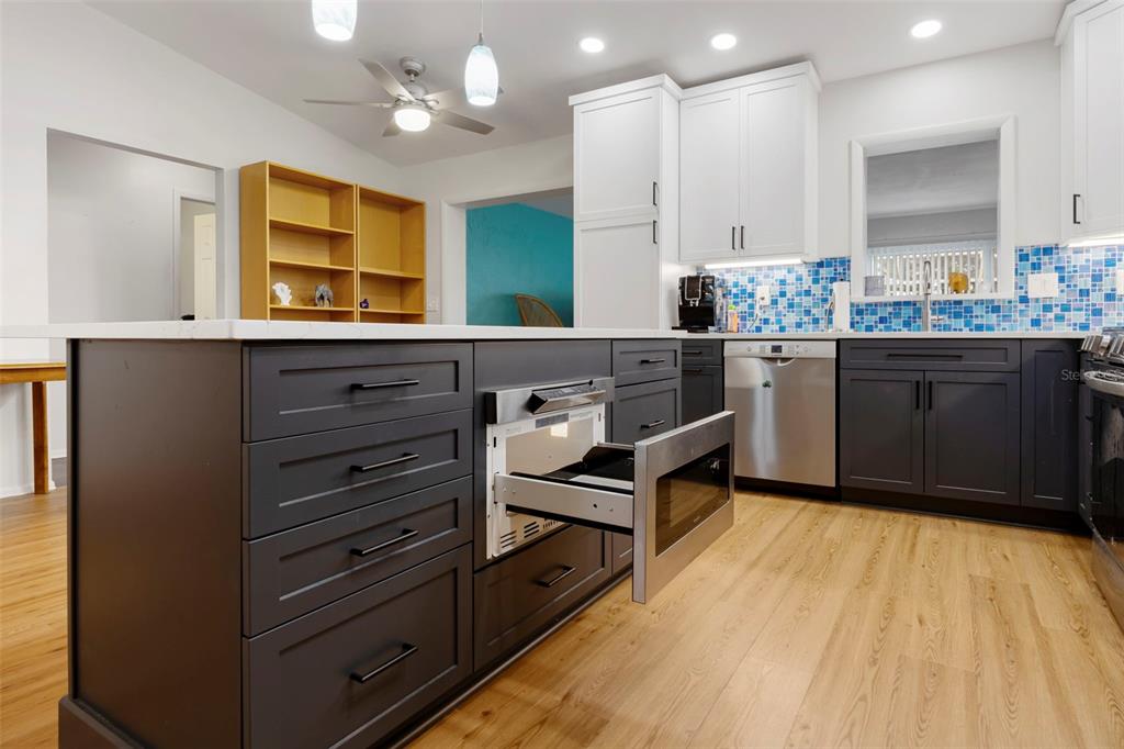 818 Eunice Drive Tarpon Springs, FL 34689 - Photo 15 of 59 a kitchen with stainless steel appliances granite countertop a stove a sink and a refrigerator