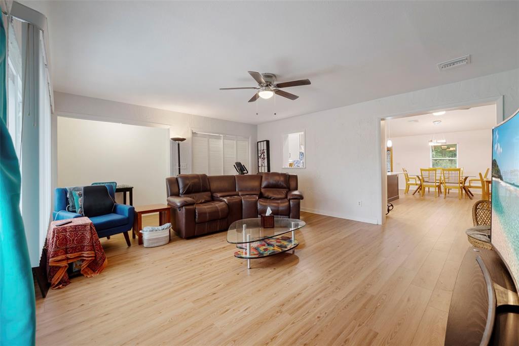 818 Eunice Drive Tarpon Springs, FL 34689 - Photo 21 of 59 a living room with furniture and a wooden floor