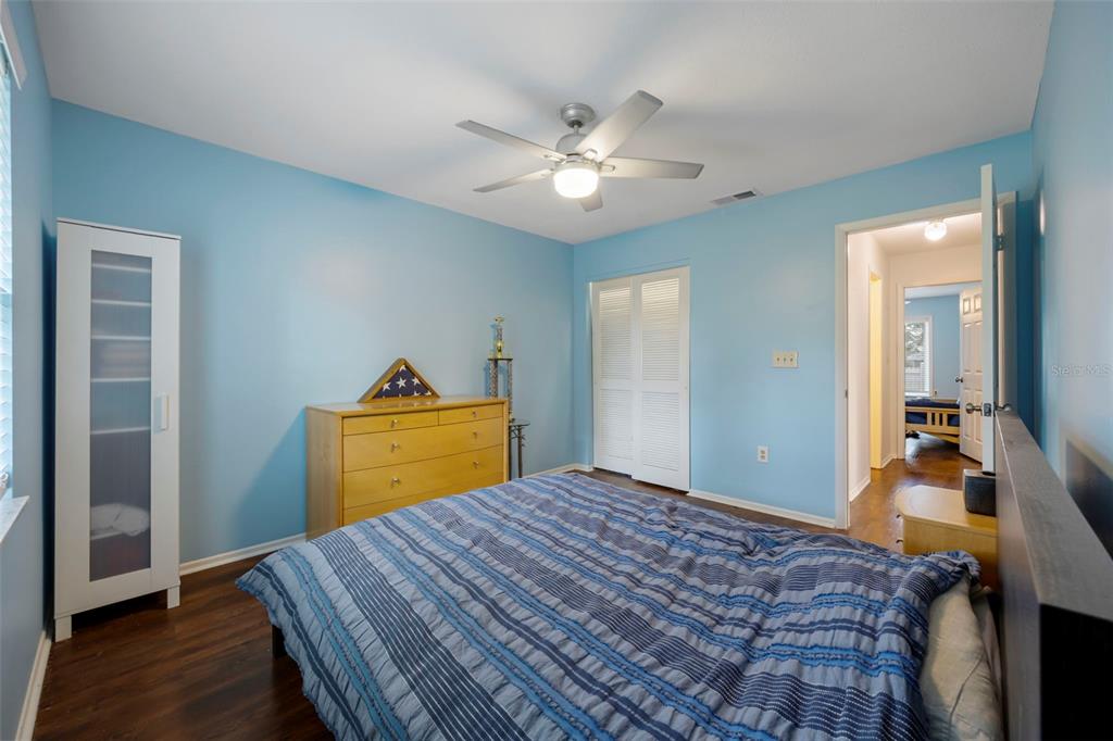 818 Eunice Drive Tarpon Springs, FL 34689 - Photo 23 of 59 a bedroom with a bed and wooden floor