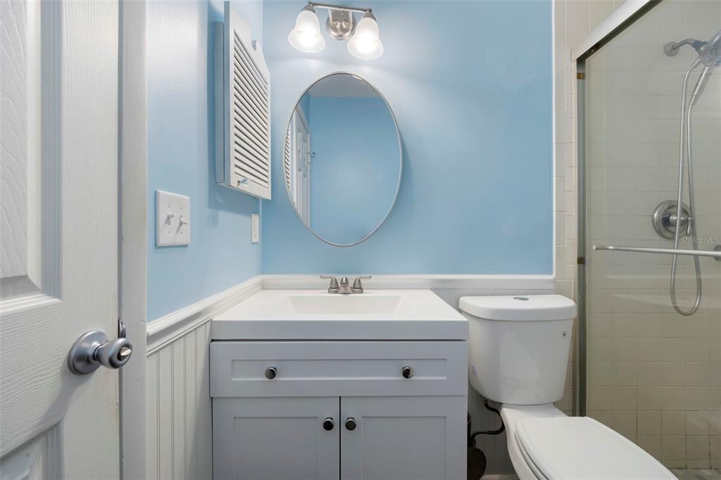 818 Eunice Drive Tarpon Springs, FL 34689 - Photo 25 of 59 a bathroom with a toilet sink and mirror