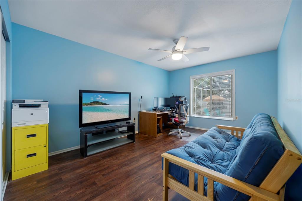 818 Eunice Drive Tarpon Springs, FL 34689 - Photo 26 of 59 a living room with furniture and a flat screen tv