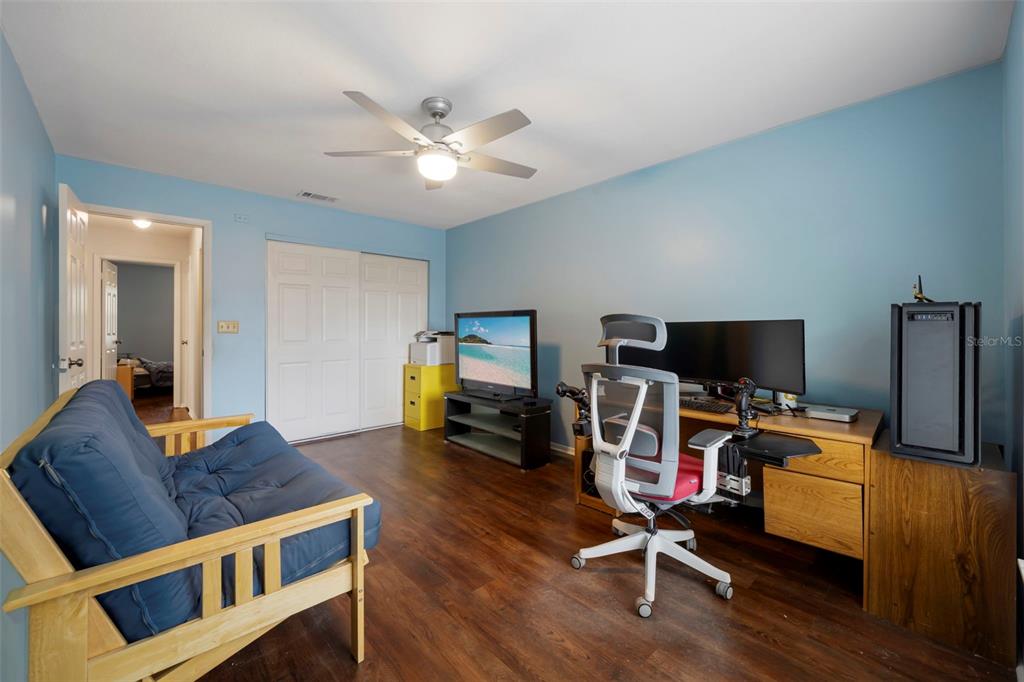 818 Eunice Drive Tarpon Springs, FL 34689 - Photo 27 of 59 a workspace with furniture and wooden floor