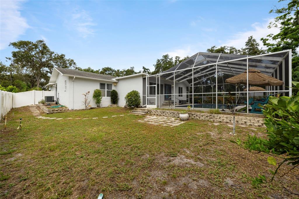 818 Eunice Drive Tarpon Springs, FL 34689 - Photo 37 of 59 a house view with a garden space